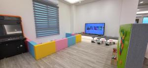 a room with a room with a tv and a room with a room at Xin Young Villa in Zhuangwei +1 photo