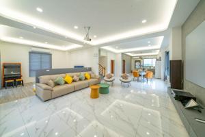 a living room with a couch and a television at Xin Young Villa in Zhuangwei