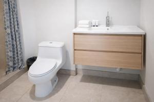 a bathroom with a white toilet and a sink at Gorgona Beach House in Nueva Gorgona +19 photos