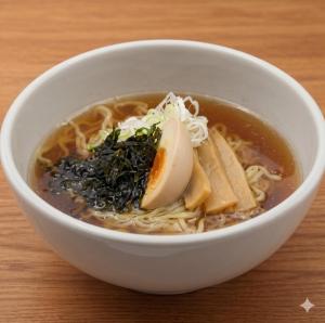 a bowl of soup with noodles and an egg in it at Dormy Inn Korakuen in Tokyo