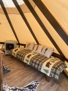 a bed in a tent with pillows on it at Simeon in Duchesne