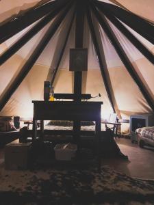 a room with a piano in a tent at Simeon in Duchesne