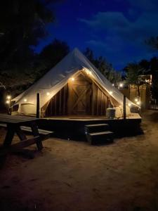 a large wooden tent with lights on it at night at Simeon in Duchesne