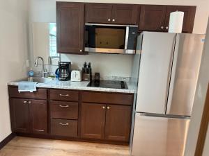 a kitchen with wooden cabinets and a white refrigerator at Airstay LLC in Clark +3 photos