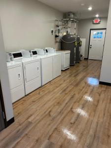 a room with white washing machines and wooden floors at Airstay LLC in Clark