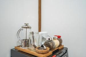 a shelf with many glass jars on top of a stove at Orora Bungalows Batu Bolong Canggu in Canggu