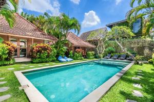 an image of a swimming pool in front of a house at Orora Bungalows Batu Bolong Canggu in Canggu