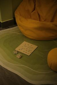 a card on the floor of a room with a chair at BeHomestay in Hai Phong