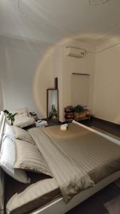 a large bed in a room with a mirror at BeHomestay in Hai Phong