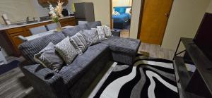 a living room with a couch with pillows on it at Cozy Hub -B in Philipsburg