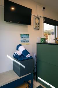 a kitchen with a counter and a cabinet and a clock at La Rochelle Motel in Akaroa