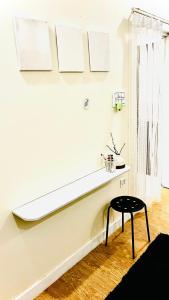 a white room with a bench and a stool at Satkarma in Rishīkesh +9 photos
