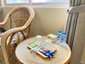 a wooden table with bottles of water on a chair at A Z Hotel Phnom Penh in Phnom Penh