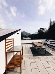 a patio with a table and chairs on a roof at Ailiv Room - Lovely Room in Capriasca in Arni Alp