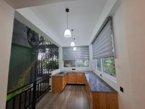 a room with a large window and a staircase at Highgarden Hideaway Villa - Gampola in Gampola