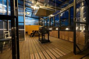 a room with a grand piano on the deck of a train at Gapyeong T Pension in Gapyeong