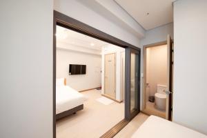 a bedroom with a bed and a sliding glass door at K-Grand Hostel Sinchon in Seoul +36 photos