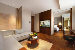 a living room with a couch and a room with a bed at Maxx by Steigenberger on the Bund Shanghai in Shanghai +110 photos