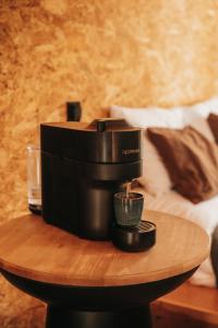 a coffee maker on a wooden table on a table at Secluded design cabin forest retreat in Cyprus in Kappedhes