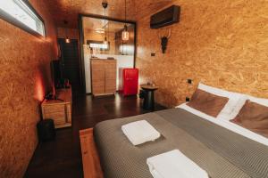 a bedroom with a bed and a television in it at Secluded design cabin forest retreat in Cyprus in Kappedhes +11 photos