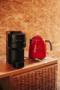 a red toaster sitting on top of a coffee maker at Secluded design cabin forest retreat in Cyprus in Kappedhes