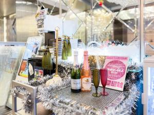 a display of wine bottles and glasses on a table at Hotel DIAMOND in Tokyo