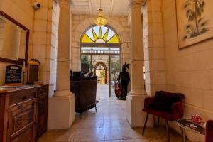 a hallway in a building with a large window at Palazzo Pisani & Spa Malta in Żabbar +92 photos