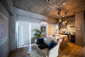 a living room with a couch and a table at Shiki Villa Beppu in Beppu