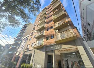 a building with balconies on the side of it at Duplex Premium Ciudad Jardín in El Palomar