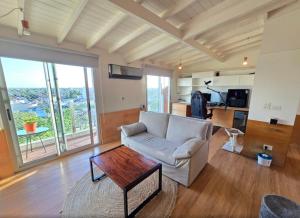 a living room with a couch and a table at Duplex Premium Ciudad Jardín in El Palomar
