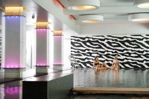 two women sitting in the water in a room at Munkebjerg Hotel in Vejle