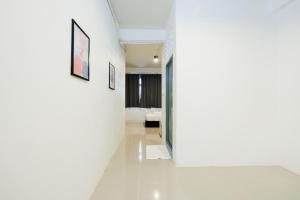 a room with white walls and a hallway with a bed at zNAP Ekkamai BTS เอกมัย 42 in Bangkok