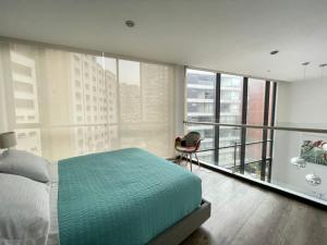 a bedroom with a bed and a balcony at ESPECTACULAR LOFT in Quito +15 photos