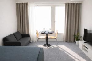 a living room with a table and a couch at Nord Heaven in Turku