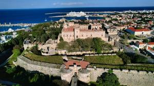 an old castle on a hill near the water at Yviome Rhodes Central Escape in Rhodes Town