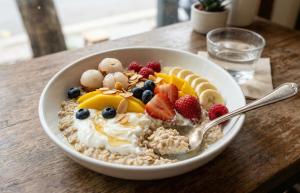 a bowl of cereal with fruit on a table at Ultra View Homestay in Sapa