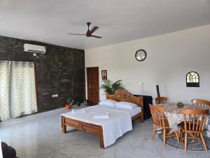a living room with a bed and a table at Dsouza Stay in Mysore