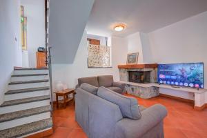 a living room with a couch and a flat screen tv at Casa al Castello in Leggiuno with Garden - Happy Rentals in Leggiuno