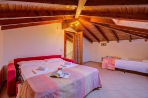 a bedroom with a bed and two beds in a room at Casa al Castello in Leggiuno with Garden - Happy Rentals in Leggiuno