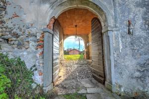 an alley in an old building with two archways at Casa al Castello in Leggiuno with Garden - Happy Rentals in Leggiuno +27 photos