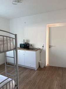 a room with a bunk bed and a desk and a door at Am Silbersee in Hochheim am Main +10 photos