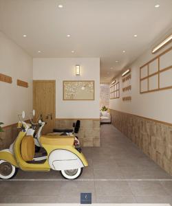 a yellow and white scooter parked in a room at Urban Nest in Hanoi