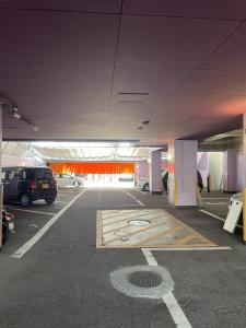 a parking lot with cars parked in a parking garage at ピンポンホテル Peace Park in Hiroshima