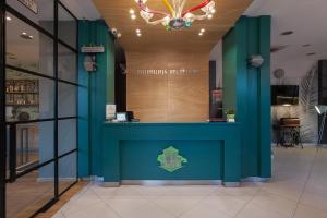 a store front with a blue and green wall at City Park Hotel in Skopje