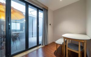 a room with a table and chairs and a window at Adena Hotel in Busan