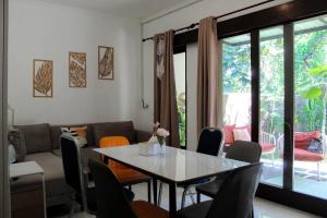 a dining room with a table and chairs at Charming 2BR Home Close to Pering Beach Gianyar in Saba