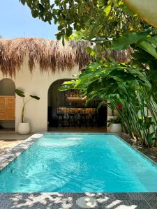 a swimming pool in front of a villa at BIG WAVES BOUTIQUE HOTEL SIARGAO in General Luna