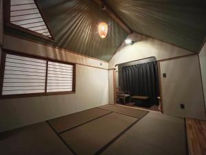 an empty room with a table and a window at ROHAUS Entire Home with private Hot Spring in Shiraoi