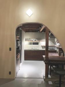 a kitchen with an archway and a table in a room at ROHAUS Entire Home with private Hot Spring in Shiraoi