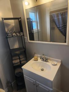 a bathroom with a sink and a mirror at Sword and Dove Rental in Spirit River +25 photos